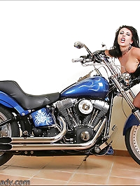 Vixen poses on a motorcyle