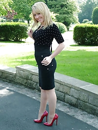 Cheeky blonde with very sexy red high heels on posing..