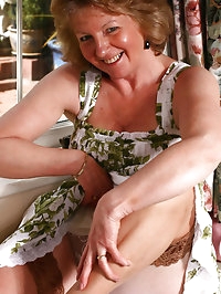 Sue in a flowery dress and tanned stockings